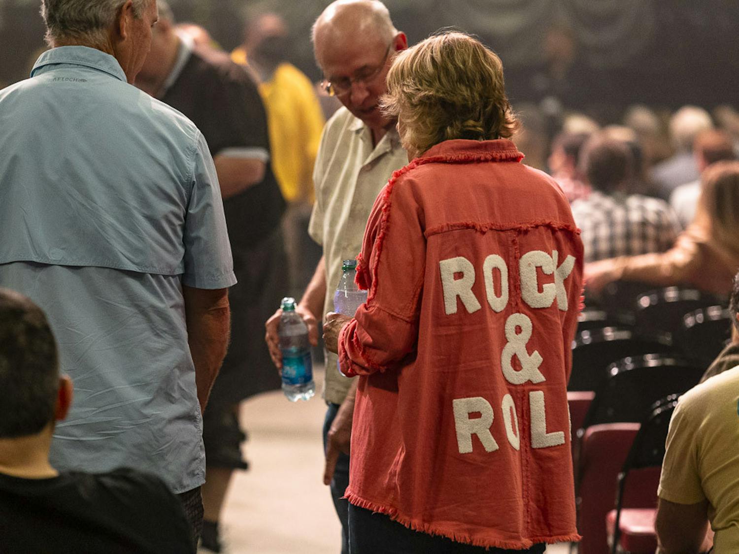 A fan with a jean jacket reading "Rock &amp; Roll" finds her seat prior to the Eagles concert at Colonial Life Arena in Columbia, South Carolina, on March 30, 2023. Fans of all ages attended the event, and the band performed songs from its "Hotel California" album as well as some of its greatest hits.