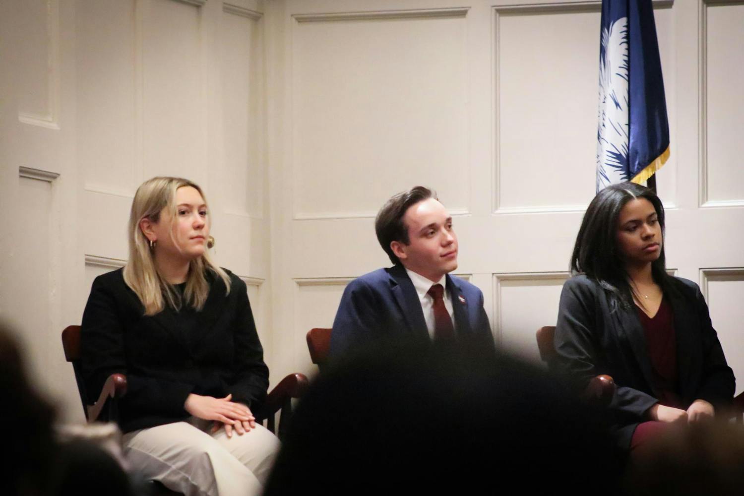 Hannah Augsbach Lamma (left), Cameron Eubanks (middle) and Abrianna Reaves (right) sit at the front of Rutledge Chapel, listening to Student Body President Emmie Thompson give her State of the Student Body address on Feb. 1, 2023. The State of the Student Body took place in Rutledge Chapel on the Horseshoe at the University of South Carolina.