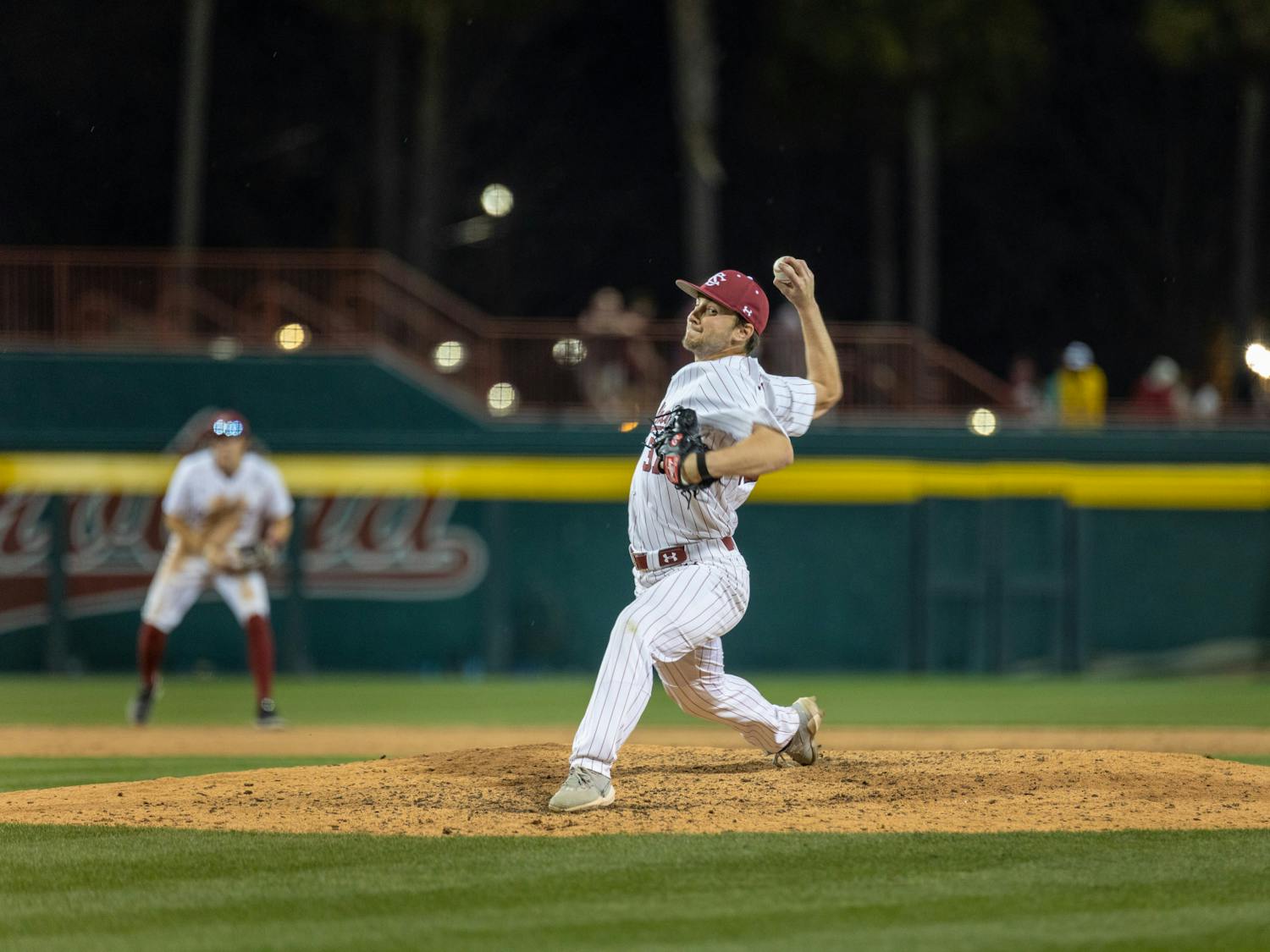 Preparing to throw the ball, redshirt sophomore pitcher and infielder Chris Veach makes eye contact with the Gamecock catcher in a game against UPenn at Founders Park on Feb. 24, 2023. South Carolina had won both games so far in its three-game series, with the first score being 7-4 and the other 1-0. 