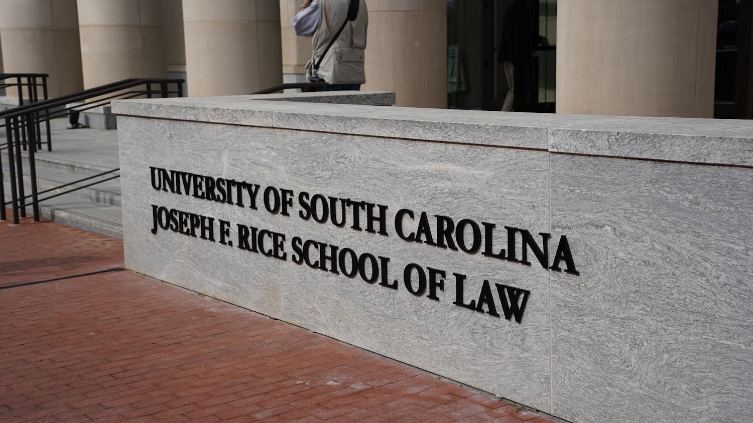 FILE — University of South Carolina unveils one of two new signage a the Senate Street entrance of the law school building on Nov. 10, 2023. The newly named Joseph F. Rice School of Law comes after Joseph F. Rice donates money towards scholarships for law students.