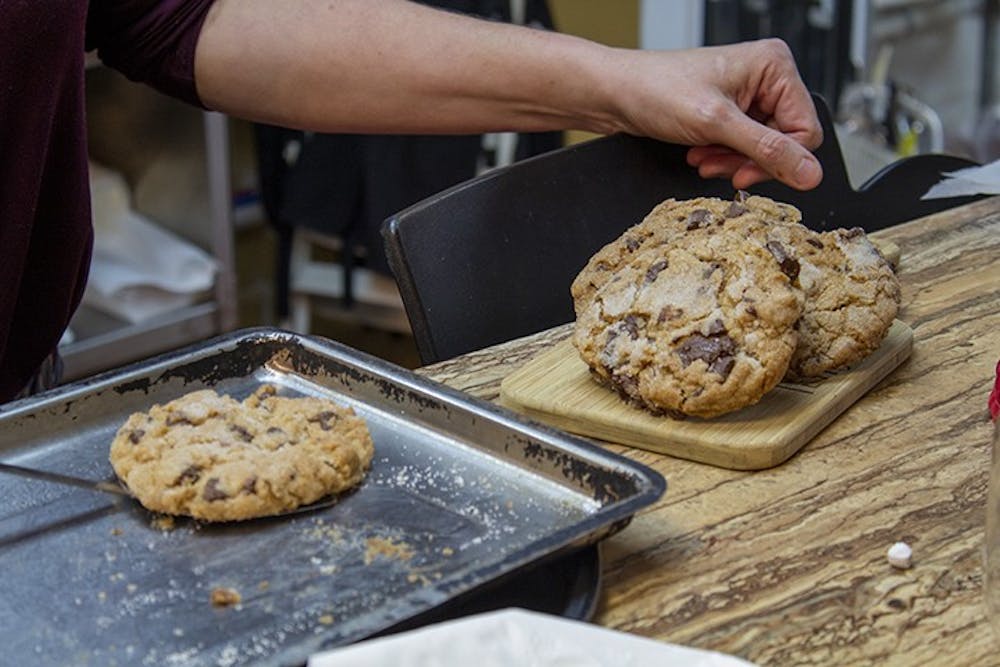 <p>The Local Buzz owner Stephanie Bridgers prepares freshly baked, gluten-free lavender chocolate chip cookies to be sold. The Local Buzz is located on Harden Street in Five Points.</p>