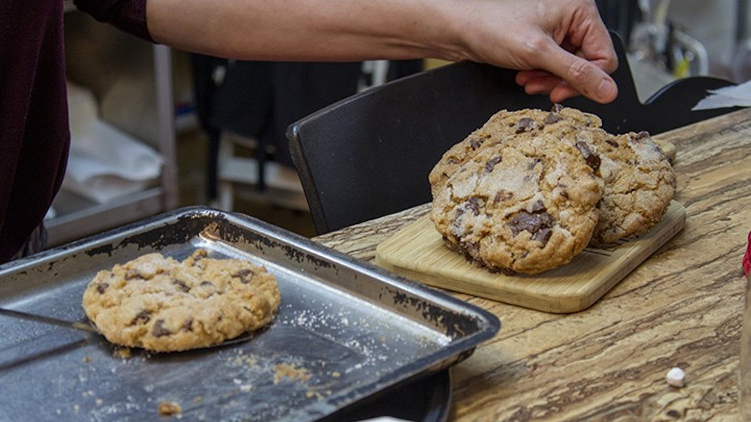 The Local Buzz owner Stephanie Bridgers prepares freshly baked, gluten-free lavender chocolate chip cookies to be sold. The Local Buzz is located on Harden Street in Five Points.