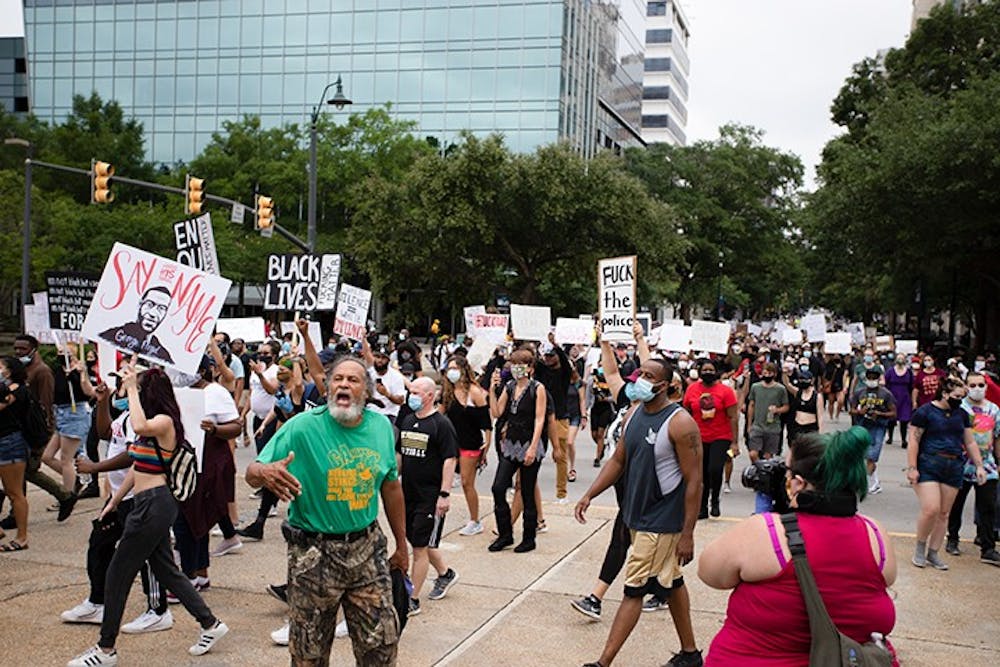 <p>People marching at the “I Can’t Breathe” protest move towards the Statehouse in Columbia on May 30.&nbsp;</p>