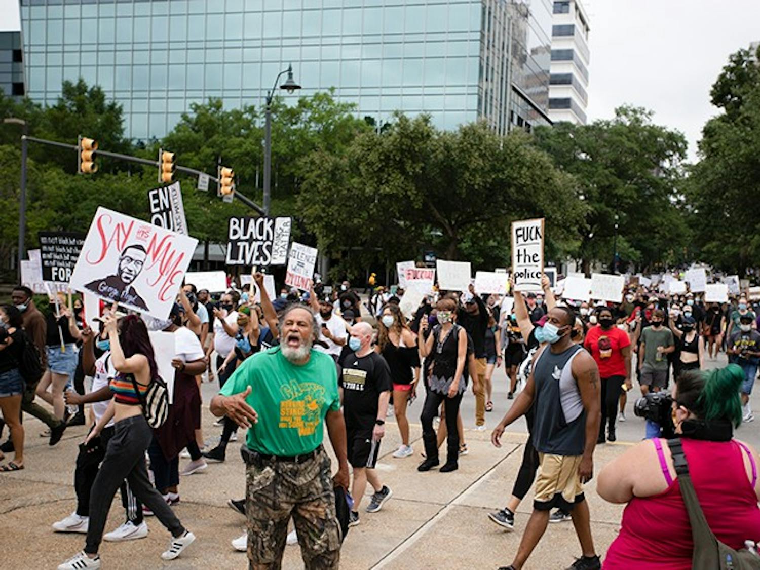 People marching at the “I Can’t Breathe” protest move towards the Statehouse in Columbia on May 30.&nbsp;