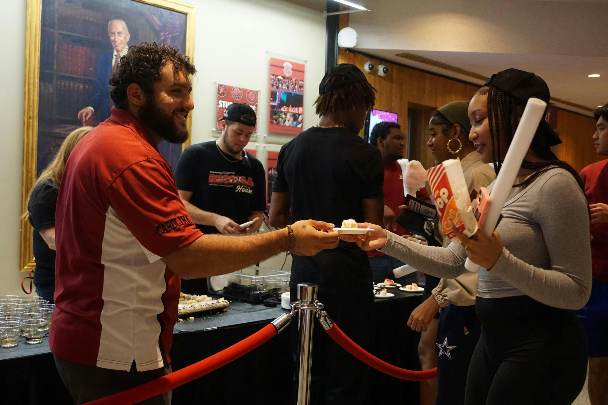 Bustle at the Russell staff hand out cake for students to take in the Russell House on Oct. 16, 2025. The Russell House will continue to grow and expand, creating new dining and meeting spaces for students, such as the newest dining hall, Garnet Station, which opened during the fall semester of 2025.