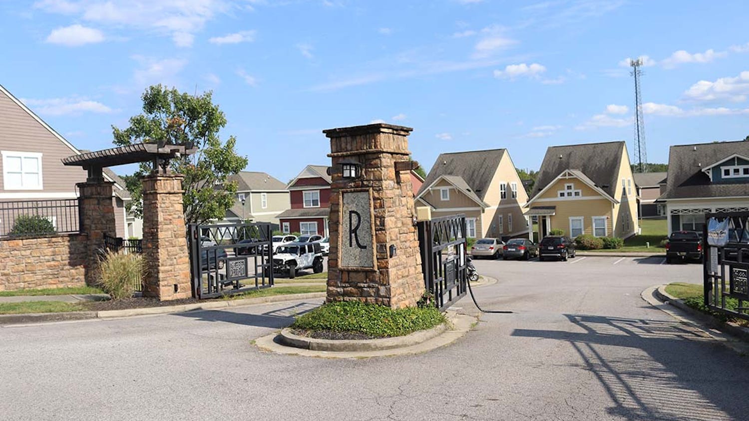 The rear entrance of The Retreat located off Zion Rd. A piece of metal is hanging off the gate in the path of vehicles.