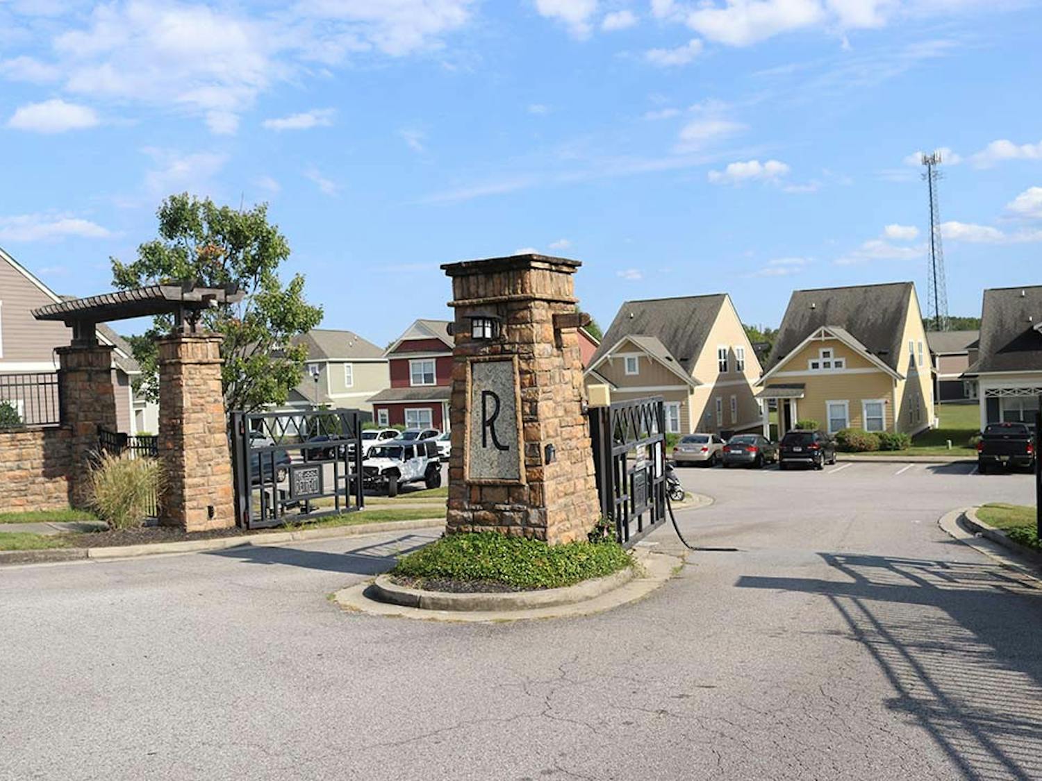 The rear entrance of The Retreat located off Zion Rd. A piece of metal is hanging off the gate in the path of vehicles.