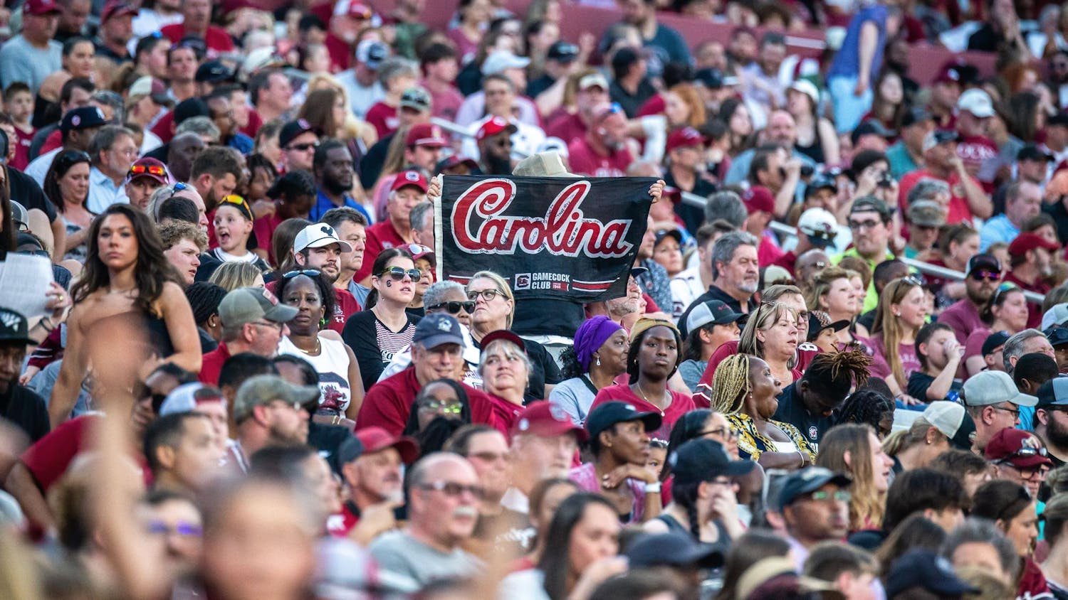A fan holds up an autographed Carolina flag during the 2024 Garnet &amp; Black Spring Game at Williams-Brice Stadium on April 20, 2024. There were 32,500 Gamecocks fans in attendance to watch the Garnet team’s 17-0 victory over the Black team.