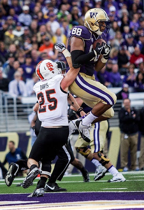 Washington&apos;s Austin Seferian-Jenkins pulls in a 6-yard touchdown pass against Idaho State&apos;s Tanner Davis during the 2nd quarter at Husky Stadium in Seattle, Washington, on Saturday, September 21, 2013. The Huskies defeated the Bengals, 56-0. (Dean Rutz/Seattle Times/MCT)