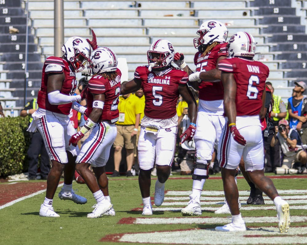 <p>FILE—Sixth-year wide receiver Dakereon Joyner (center) celebrates with his teammates after redshirt junior tight end Traevon Kenion (left) scores the first touchdown for South Carolina against Georgia on Sept. 17, 2022. The Bulldogs beat the Gamecocks 48-7.</p>