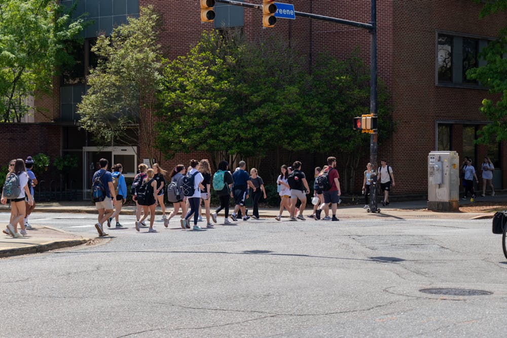 <p>Student pedestrians cross the intersection of Greene and Sumter Streets on April 5, 2023. This intersection is often one of the busiest on campus and is often jaywalked by students despite frequent traffic.</p>
