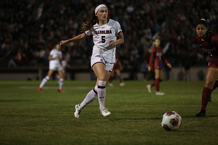 Senior forward Luciana Zullo runs while dribbling the ball towards the goal. During her career she gained a total of 13 goals with 34 points and eight assists.