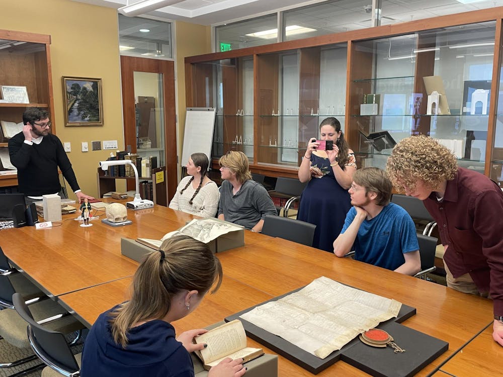 <p>Members of the Student Community for Archives, Libraries and Museums (SCALM) gather and look through collections at the Irvin Department of Rare Books and Special Collections on the campus of the University of South Carolina. SCALM aims to make it easier for students to access and appreciate special collections and historical writings.</p>