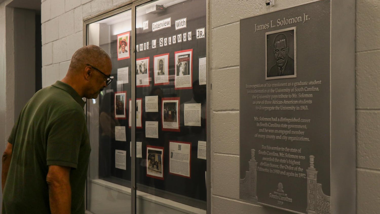 A person reads excerpts of an interview with James L. Solomon Jr. that are on display in LeConte College on Sept. 11, 2023. The College of Arts and Sciences unveiled a plaque in honor of Solomon Jr. four years after it was completed. The delay was caused by COVID-19 and construction.