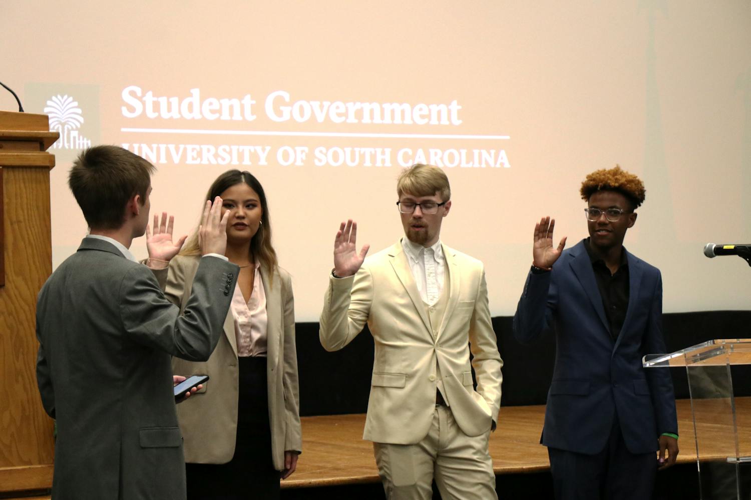 Left to right: New student senate members Abby Spitler, Brandon Miller and Camden Kaye are sworn in on Sep. 27, 2023, by Speaker pro tempore Ian Herd. Halfway through the semester, Student Government officials are focused on converting campaign goals and making progress on new initiatives.
