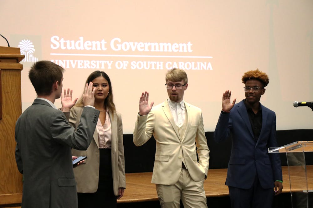 <p>Left to right: New student senate members Abby Spitler, Brandon Miller and Camden Kaye are sworn in on Sep. 27, 2023, by Speaker pro tempore Ian Herd. Halfway through the semester, Student Government officials are focused on converting campaign goals and making progress on new initiatives.</p>