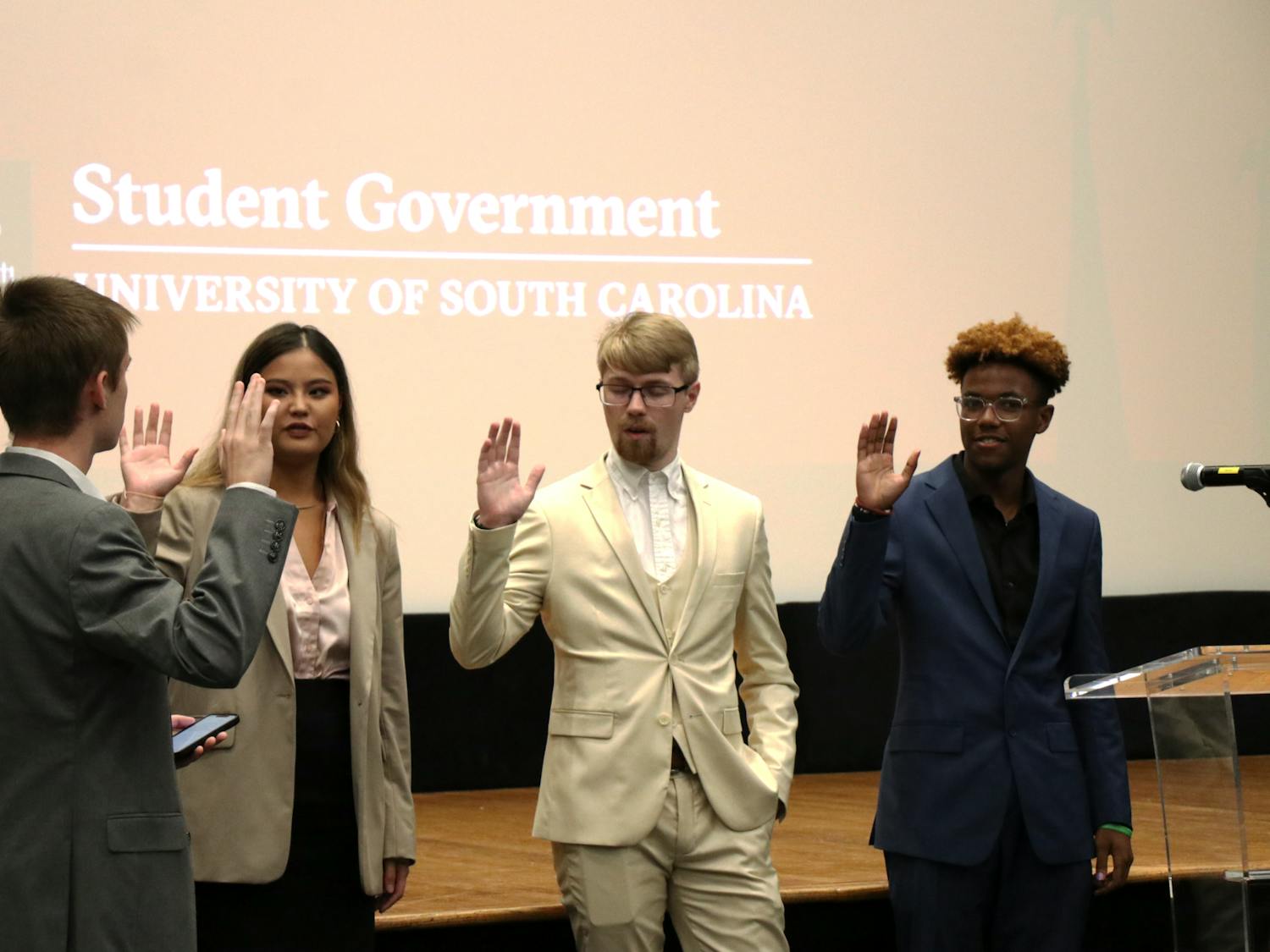 Left to right: New student senate members Abby Spitler, Brandon Miller and Camden Kaye are sworn in on Sep. 27, 2023, by Speaker pro tempore Ian Herd. Halfway through the semester, Student Government officials are focused on converting campaign goals and making progress on new initiatives.