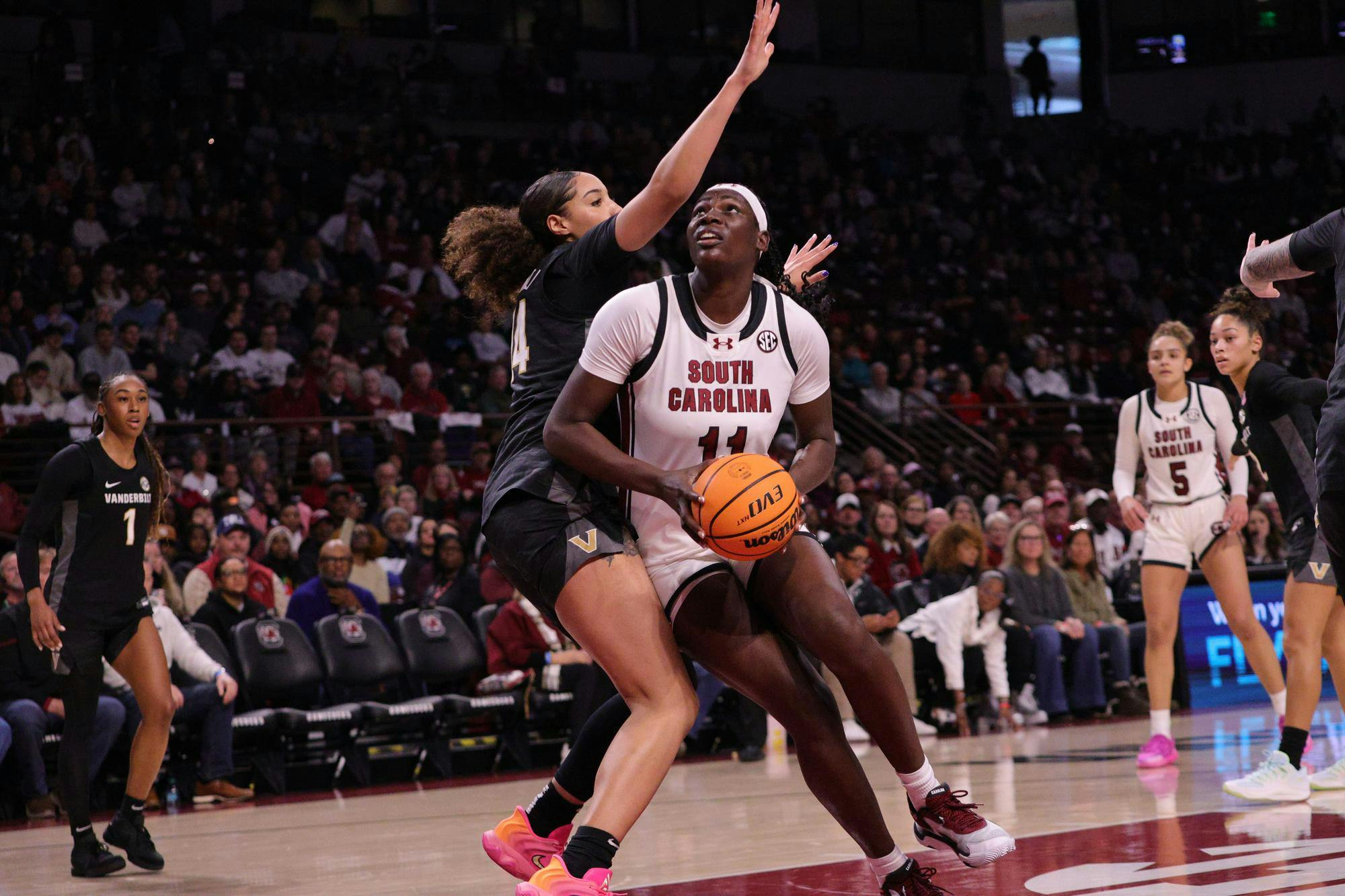 Senior center Madina Okot goes up for a layup during the Gamecocks’ matchup with Vanderbilt at Colonial Life Arena on Jan. 25. She takes the shot while a defender reaches in to stop her.