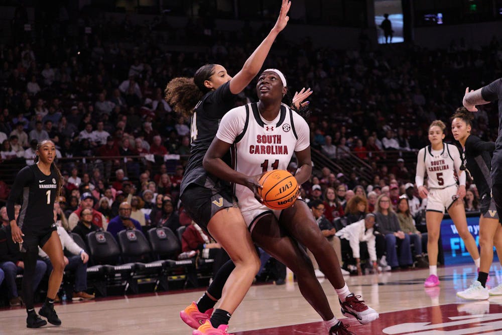 <p>Senior center Madina Okot goes up for a layup during the Gamecocks’ matchup with Vanderbilt at Colonial Life Arena on Jan. 25. She takes the shot while a defender reaches in to stop her.</p>