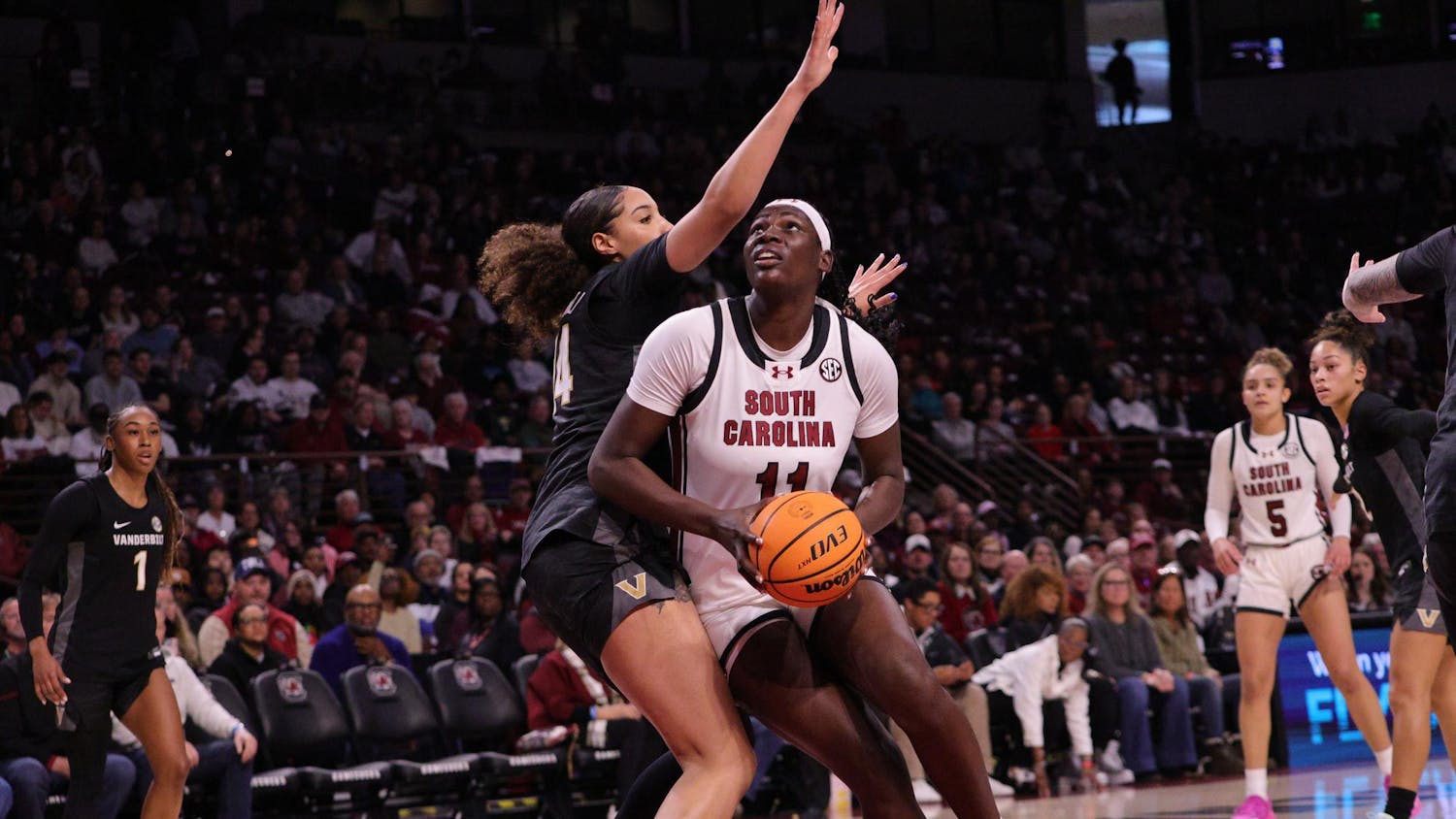 Senior center Madina Okot goes up for a layup during the Gamecocks’ matchup with Vanderbilt at Colonial Life Arena on Jan. 25. She takes the shot while a defender reaches in to stop her.