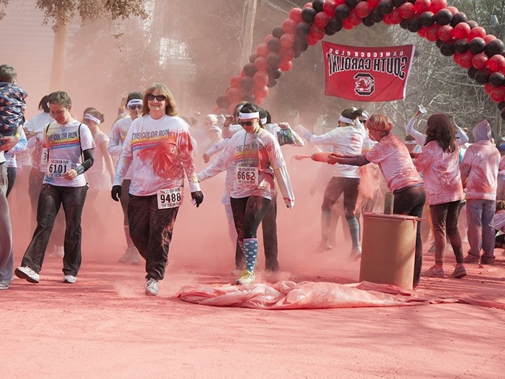 More than a thousand runners and walkers are covered in garnet powder Saturday morning.