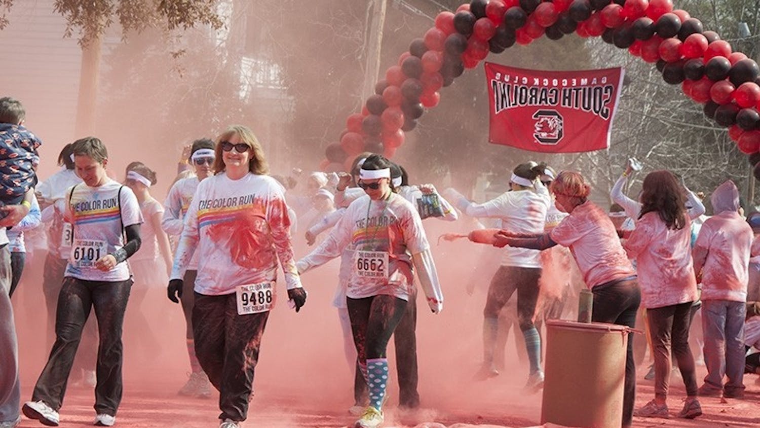 More than a thousand runners and walkers are covered in garnet powder Saturday morning.