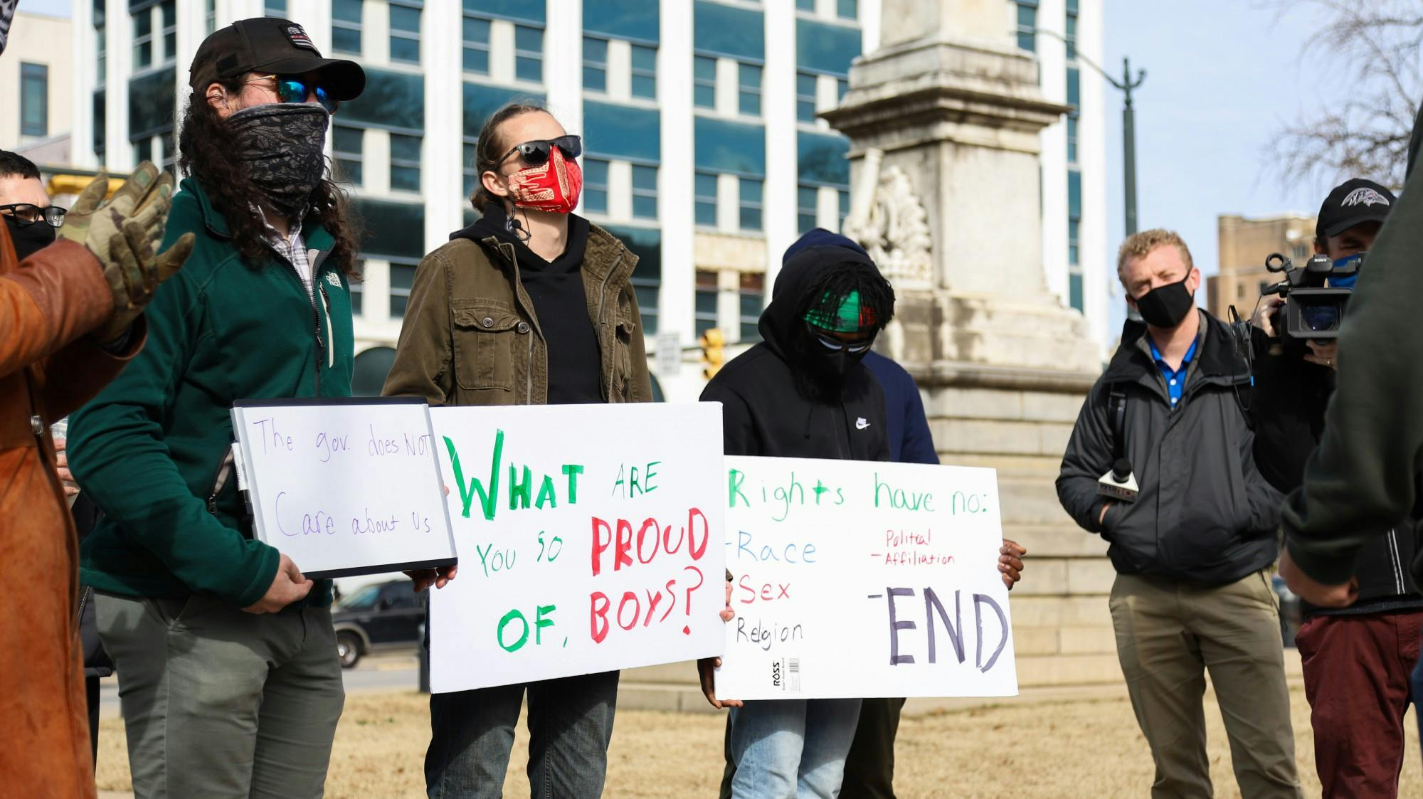 Counter-protesters hold signs in protest of the “Drive4America” caravan, one reading “What are you so proud of, boys?” Shawn Laurie, head organizer of the “Drive4America” caravan, conversed with them, both groups agreeing on some matters.&nbsp;