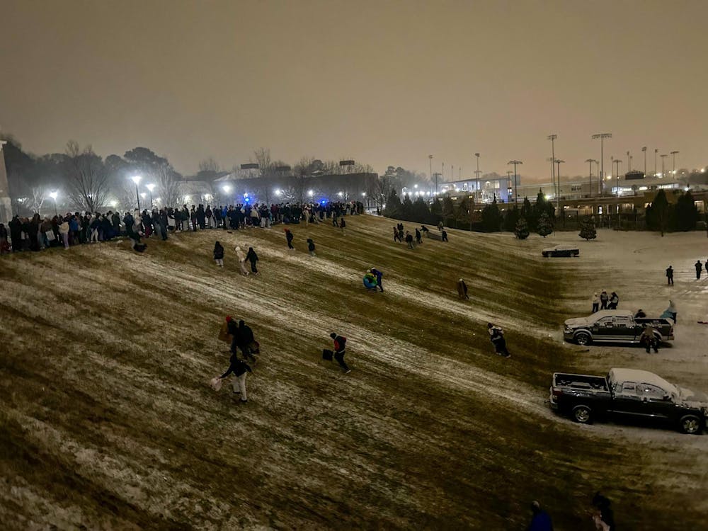 <p>University of South Carolina students gather to sled down a hill near Campus Village after snow covered the ground on the evening of Jan. 21, 2025. The university cancelled classes after noon on Jan. 21, with many students choosing to go outside and enjoy the rare weather.</p>