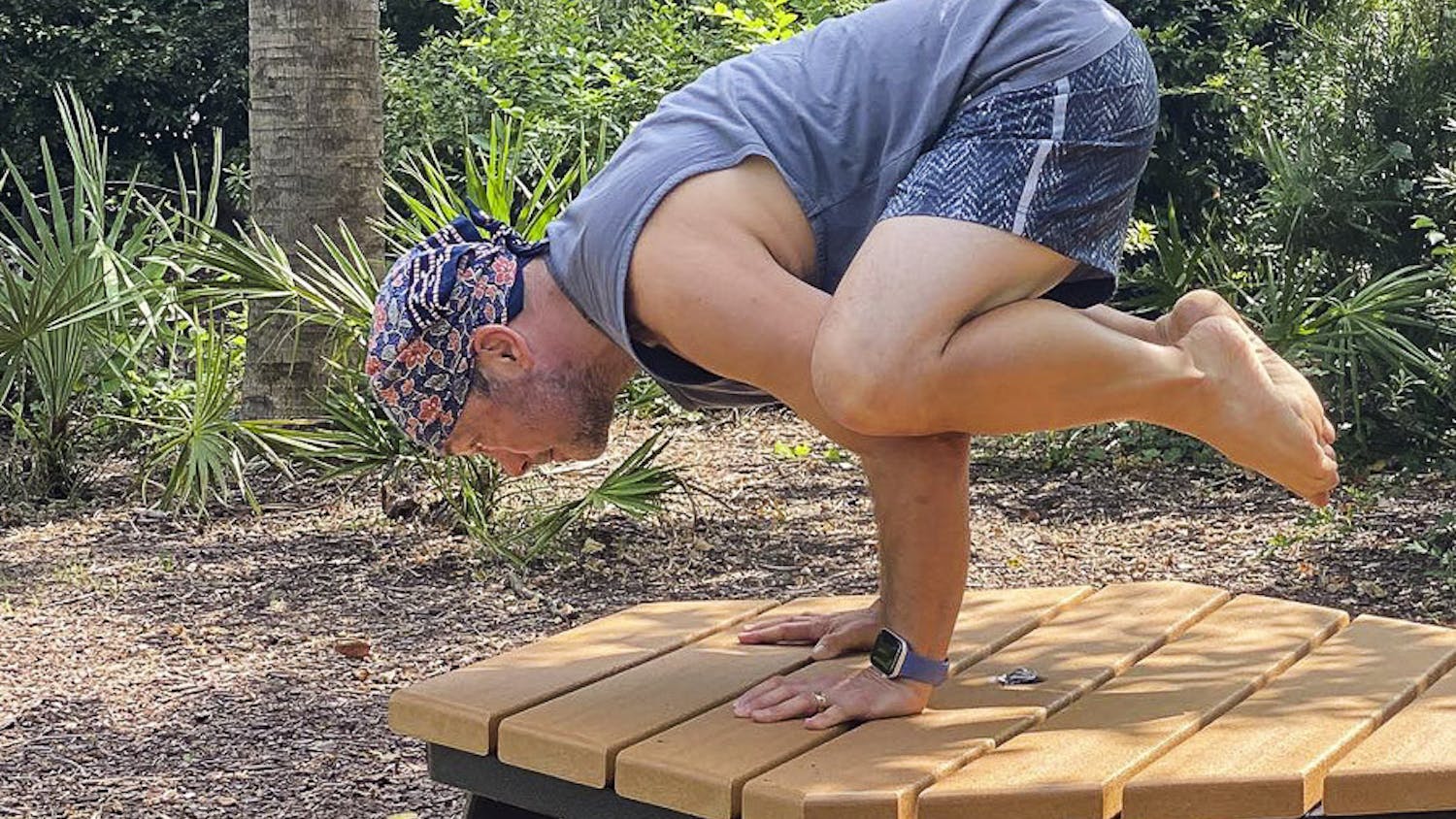 David Moscowitz, a professor at the School of Journalism and Mass Communications stands in the Bakasana yoga pose, a.k.a. the Crow Pose. Moscowitz offers donation-funded yoga lessons at Rooted Yoga, on Sunday afternoons.&nbsp;