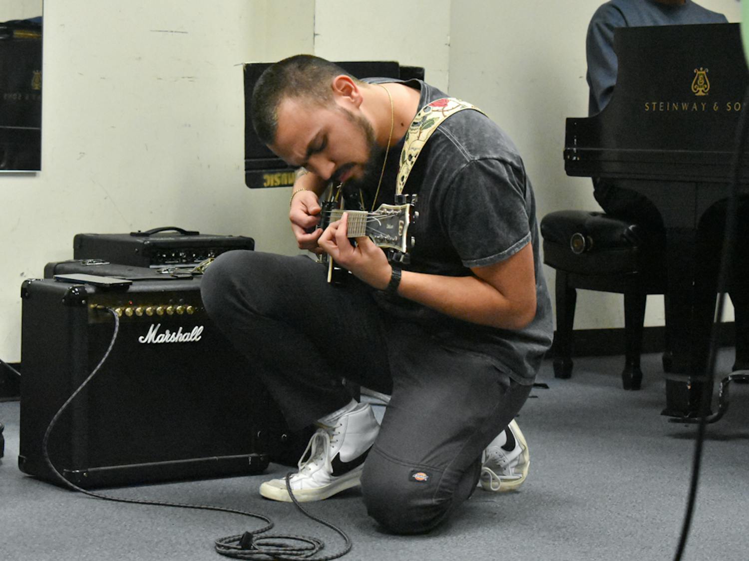 Bell plays the electric guitar for the commercial music ensemble class on Feb. 7, 2023. In the class, students play and rehearse together for future performances.