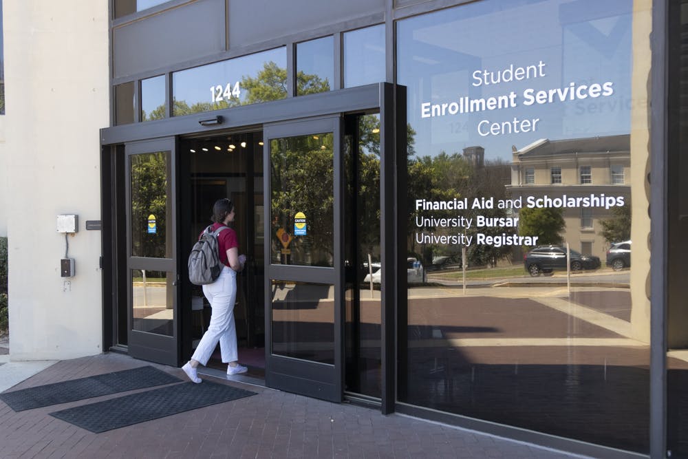 Fourth-year international business student Sarah Cowman walks into the Student Enrollment Services Center on March 21, 2023. The building, which sits on the corner of Blossom and Sumter Street, houses the Office of Student Financial Aid and scholarships, the University Bursar’s Office and the Office of the University Registrar, which are the offices in charge of taking care of student financial obligations.
