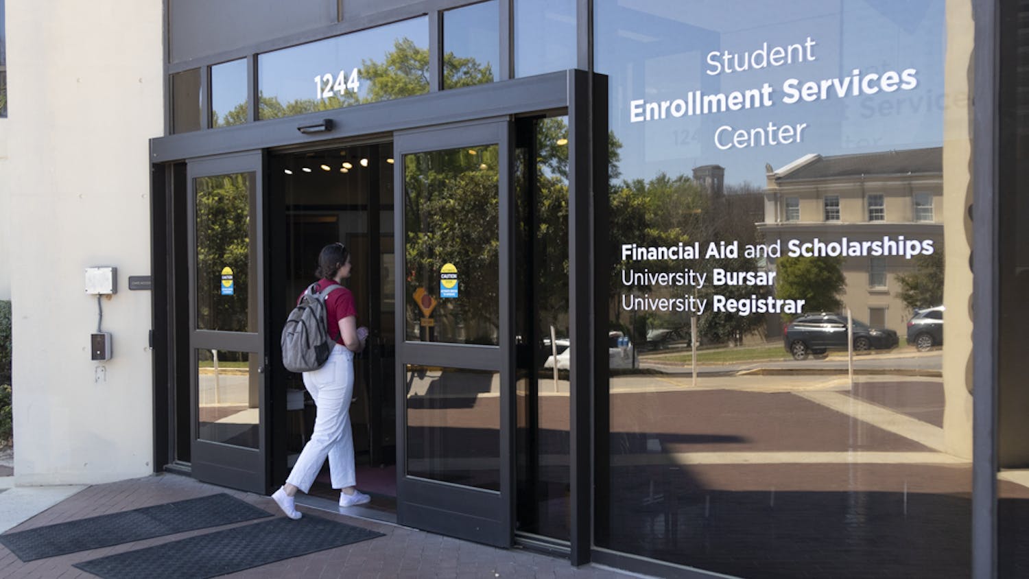 Fourth-year international business student Sarah Cowman walks into the Student Enrollment Services Center on March 21, 2023. The building, which sits on the corner of Blossom and Sumter Street, houses the Office of Student Financial Aid and scholarships, the University Bursar’s Office and the Office of the University Registrar, which are the offices in charge of taking care of student financial obligations.
