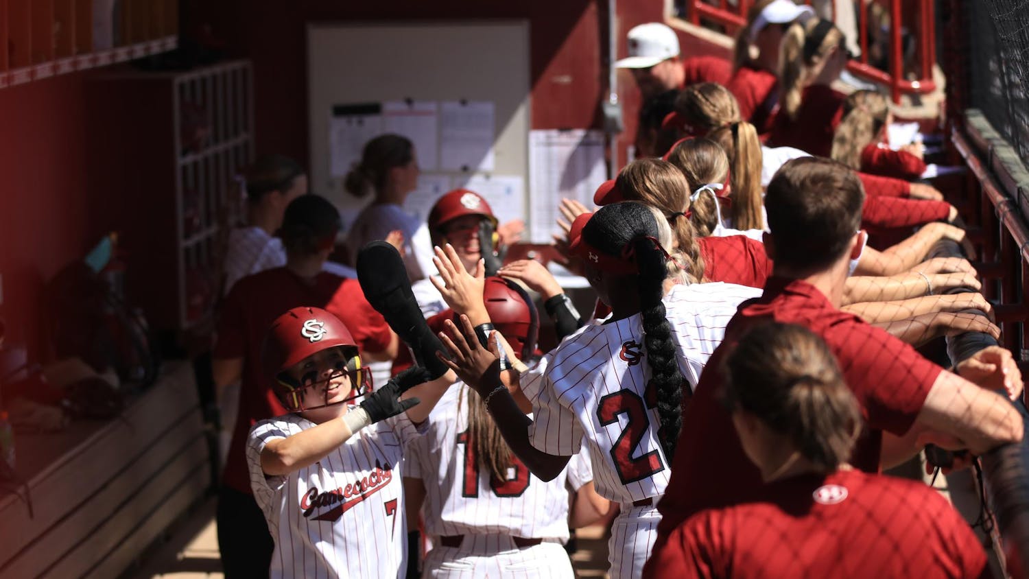 The University of South Carolina softball team congratulates each other after two players made it back to home plate at Carolina Softball Stadium during the game on Mar. 23, 2025. The Gamecocks lost to the Texas Tech Red Raiders, 5-6, in a close matchup. 