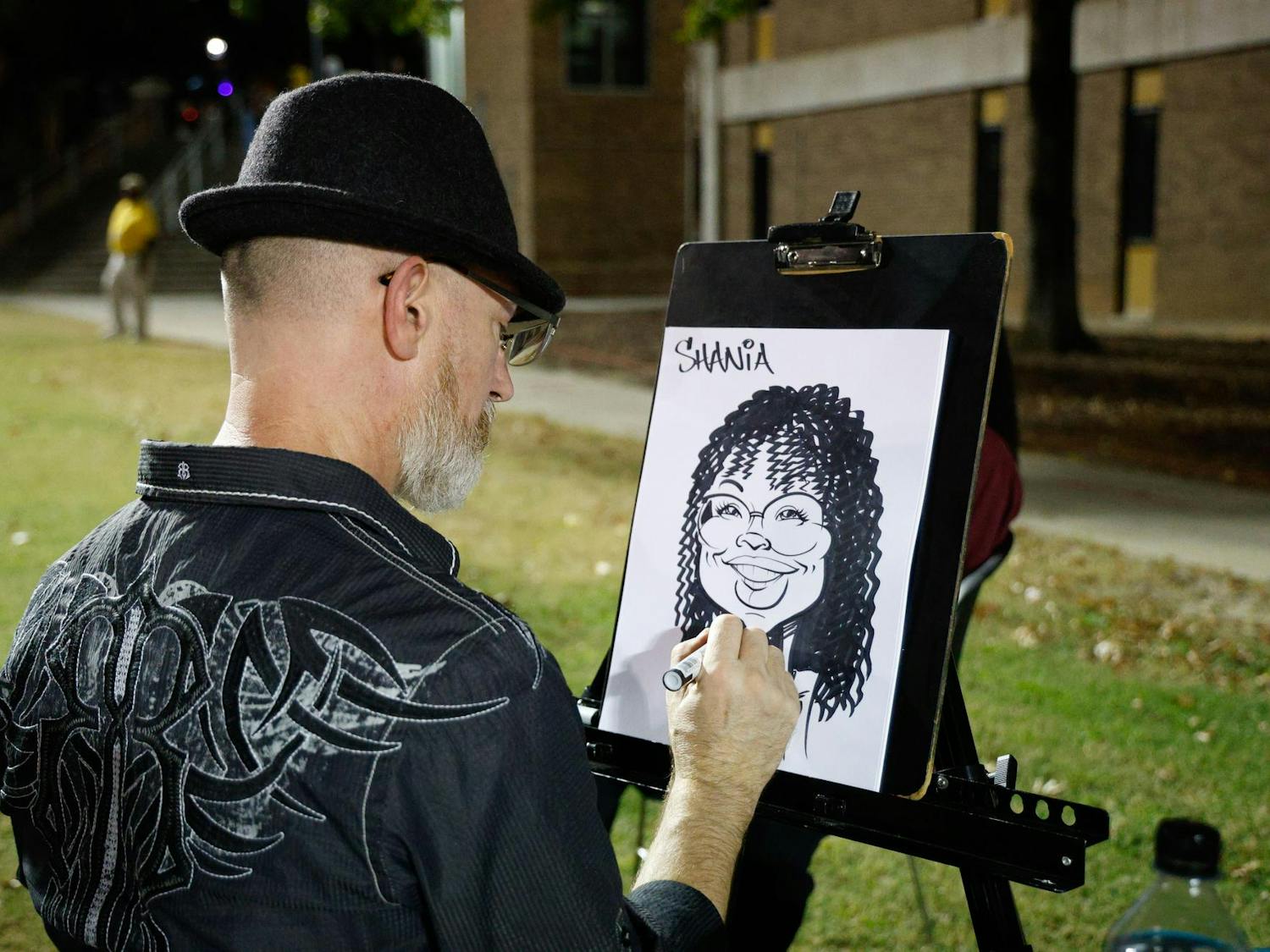 A caricature artist draws a piece at his booth at Blatt Bonanza on Sept. 18, 2024, at Blatt Field. Students could get a drawing of themselves as a part of the event.