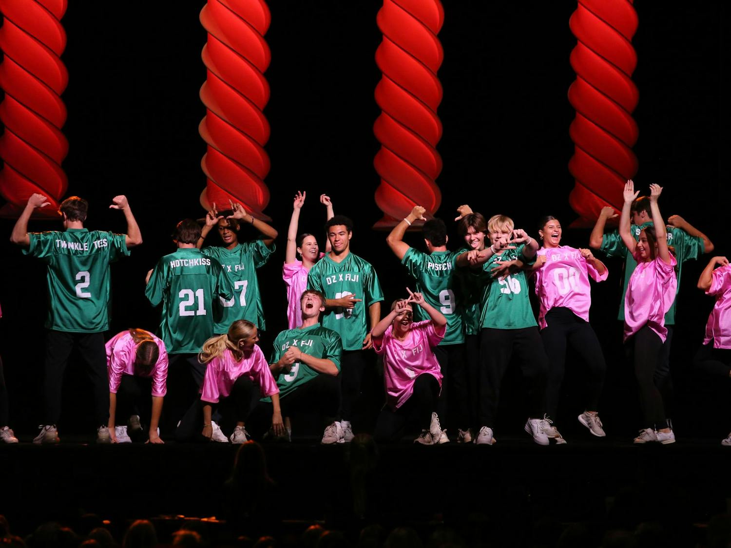 Sisters of Delta Zeta and brothers of Phi Gamma Delta perform together during Spurs and Struts on Oct. 11, 2023. The two organizations sported opposing green and pink jerseys for their performance at the Columbia Metropolitan Convention Center.