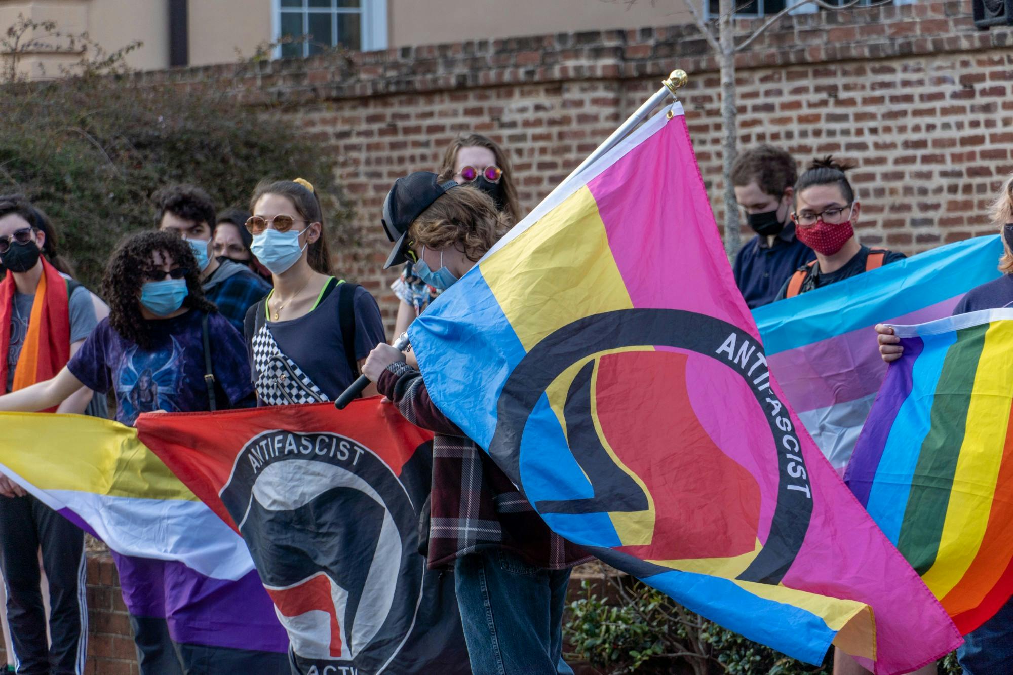 A group of protesters carry flags and give speeches on Greene St. during an anti-hate speech protest on Feb. 24, 2022. The protest came in response to recent comments from Turning Point USA.  