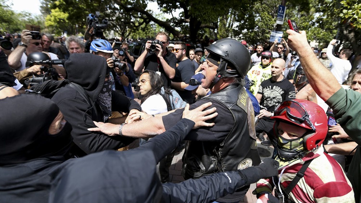 Anti- and pro-Trump supporters clash during competing demonstrations at Martin Luther King Jr. Civic Center Park in Berkeley, Calif., on Saturday, April 15, 2017. (Anda Chu/Bay Area News Group/TNS)