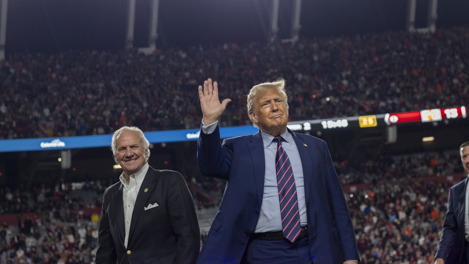 Donald Trump, the 45th president of the United States, waves with South Carolina Gov. Henry McMaster at Williams-Brice Stadium on Nov. 25, 2023. His appearance drew a mixture of praises and boos from the crowd. 