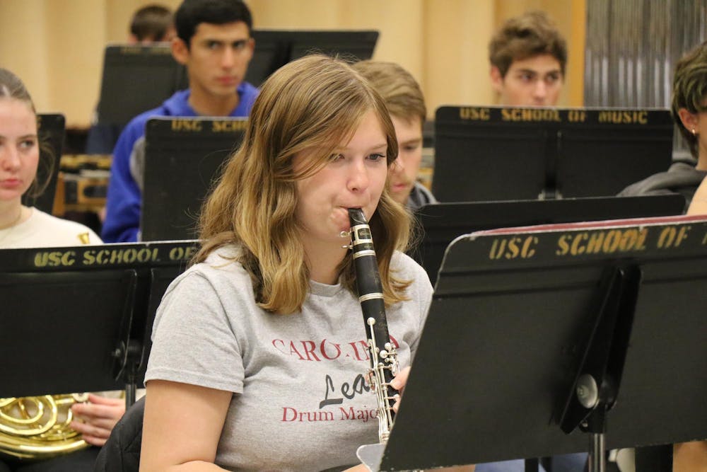 <p>First-year music student Bryce Vrtis concentrates on the sheet music while playing the clarinet. The band practiced Ecstatic Waters, which was put together by Steven Bryant.</p>