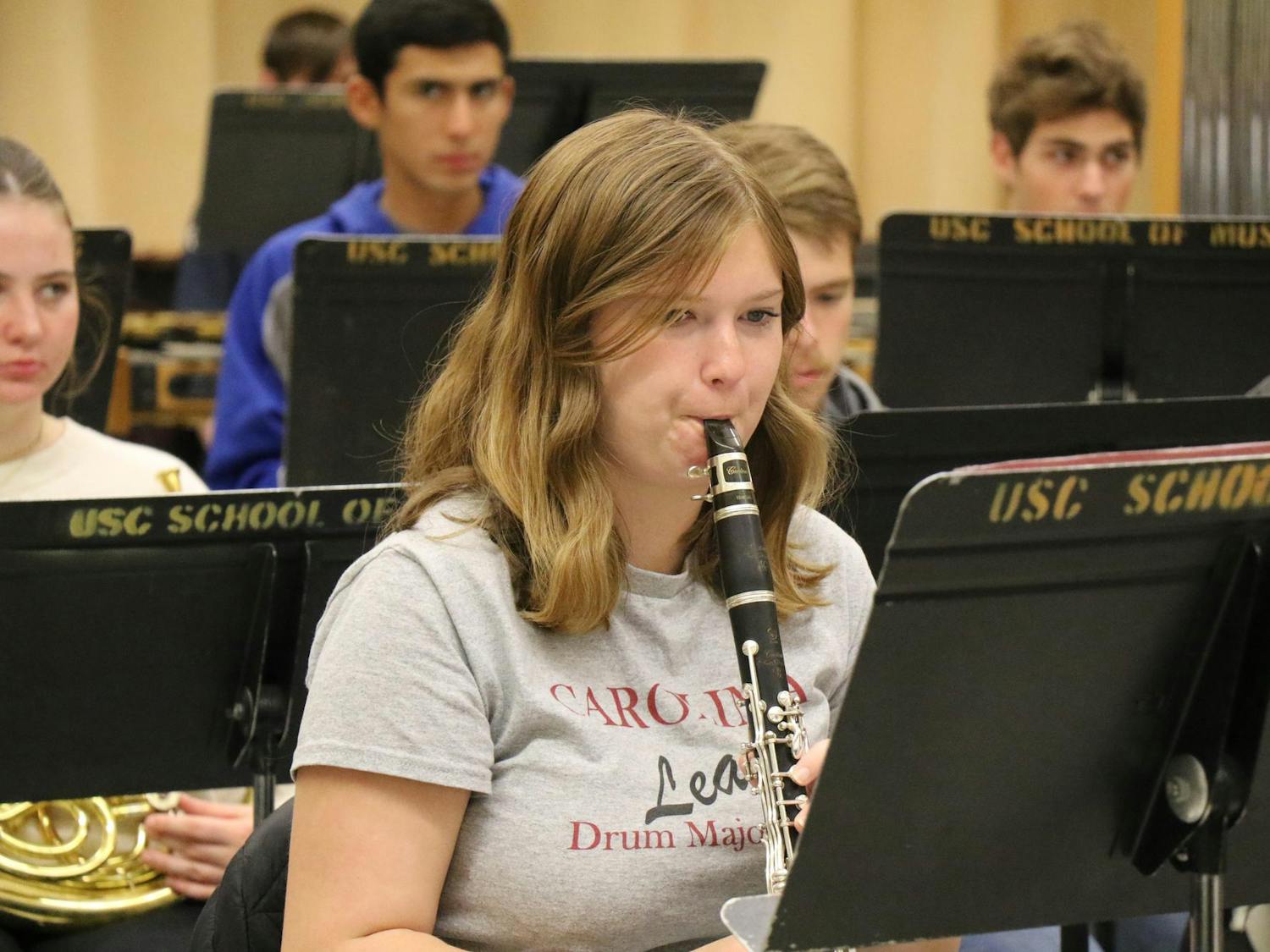 First-year music student Bryce Vrtis concentrates on the sheet music while playing the clarinet. The band practiced Ecstatic Waters, which was put together by Steven Bryant.