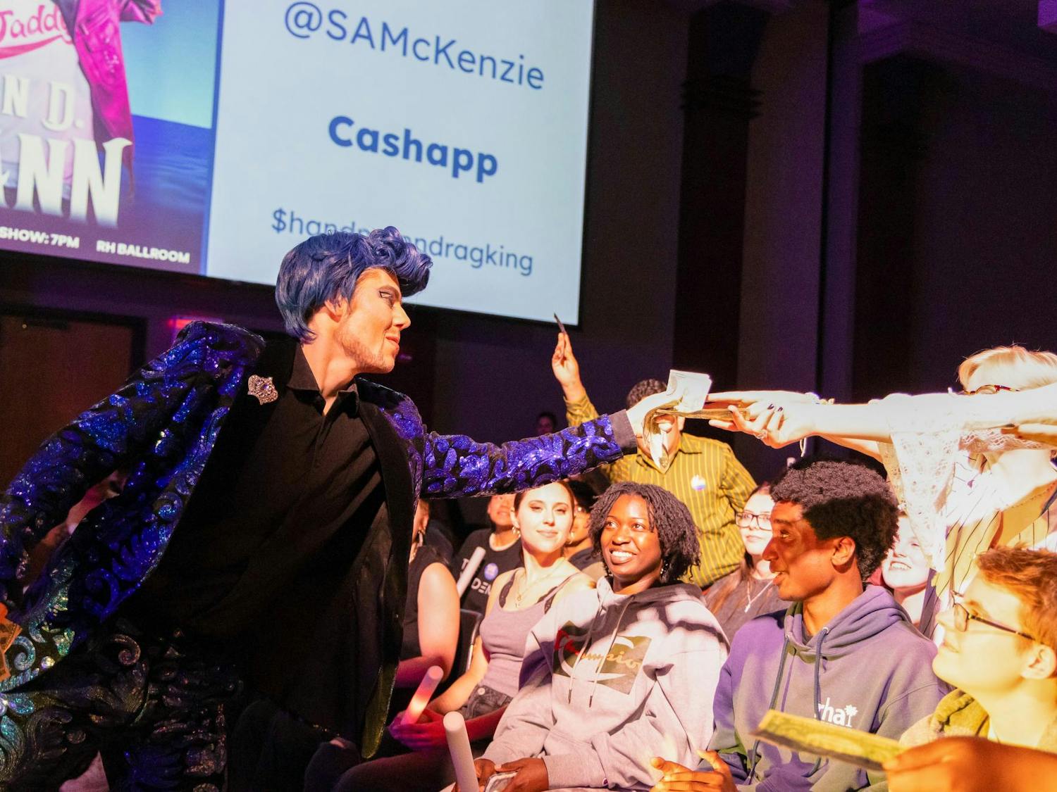 Drag king Han D. Mann grabs tips from audience members at Birdcage on April 16, 2025. Mann is a part of local drag group Kings N' Things that features a variety of local drag talent.