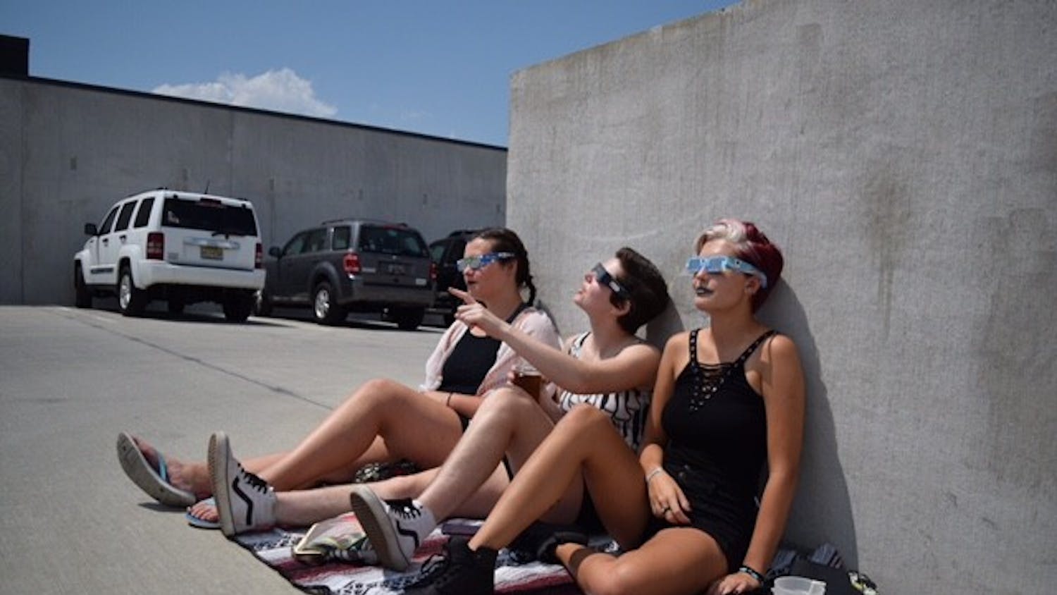 Students wear their protective glasses while watching the total solar eclipse on the top of a parking garage Aug. 21, 2017.