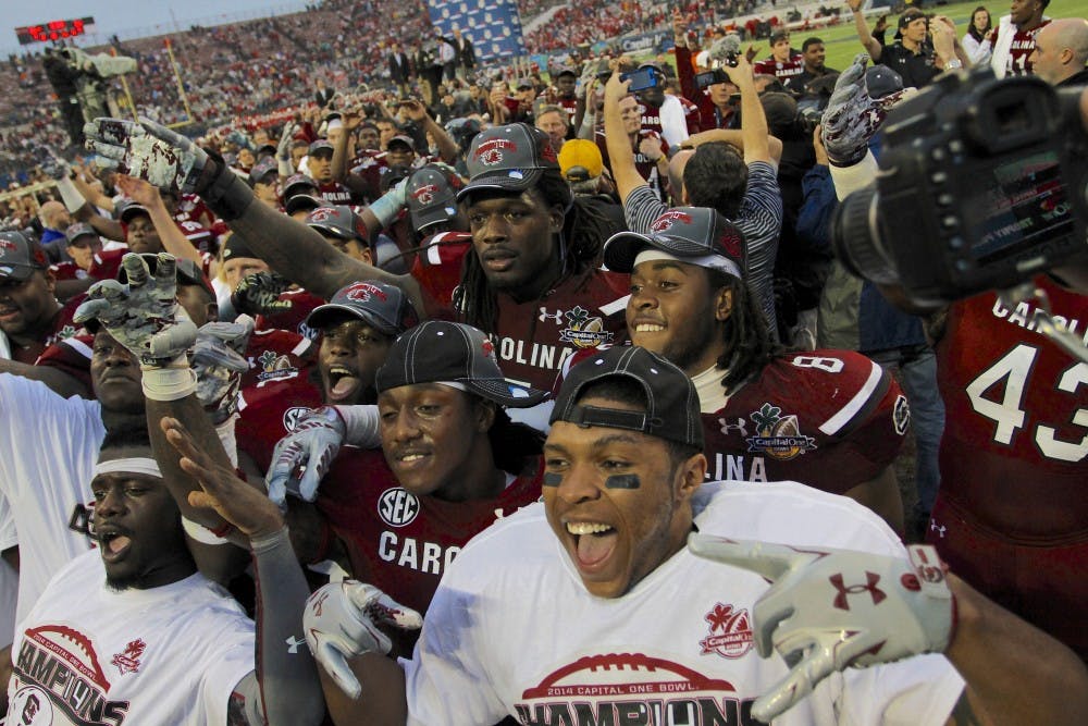	Junior defensive end Jadeveon Clowney poses with teammates after the Gamecocks beat the Wisconsin Badgers 34-24 at the Capital One Bowl on Jan. 1.