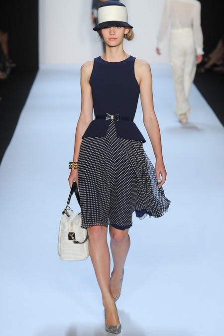 	The cinched waist, hair, and full skirt make for a 40s tone at Badgley Mischka.