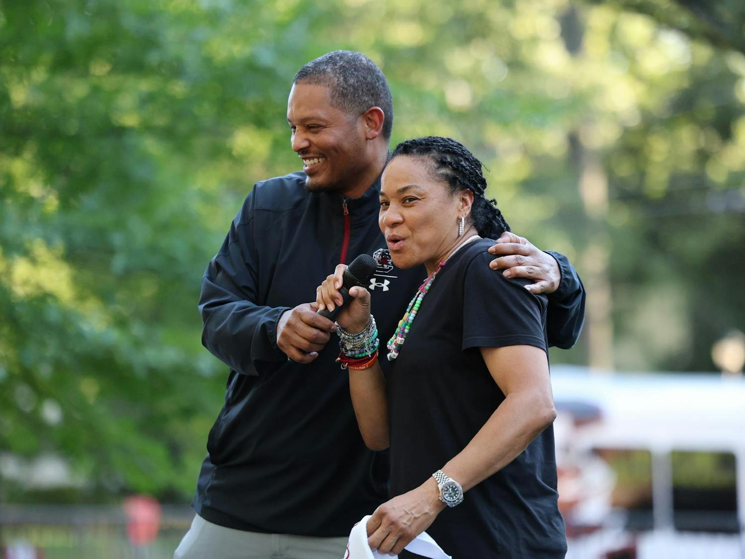 Head men’s basketball coach Lamont Paris embraces head women’s basketball coach Dawn Staley during the First Night Carolina event on Aug. 19, 2024. Paris and Staley spoke to students as part of the annual event.