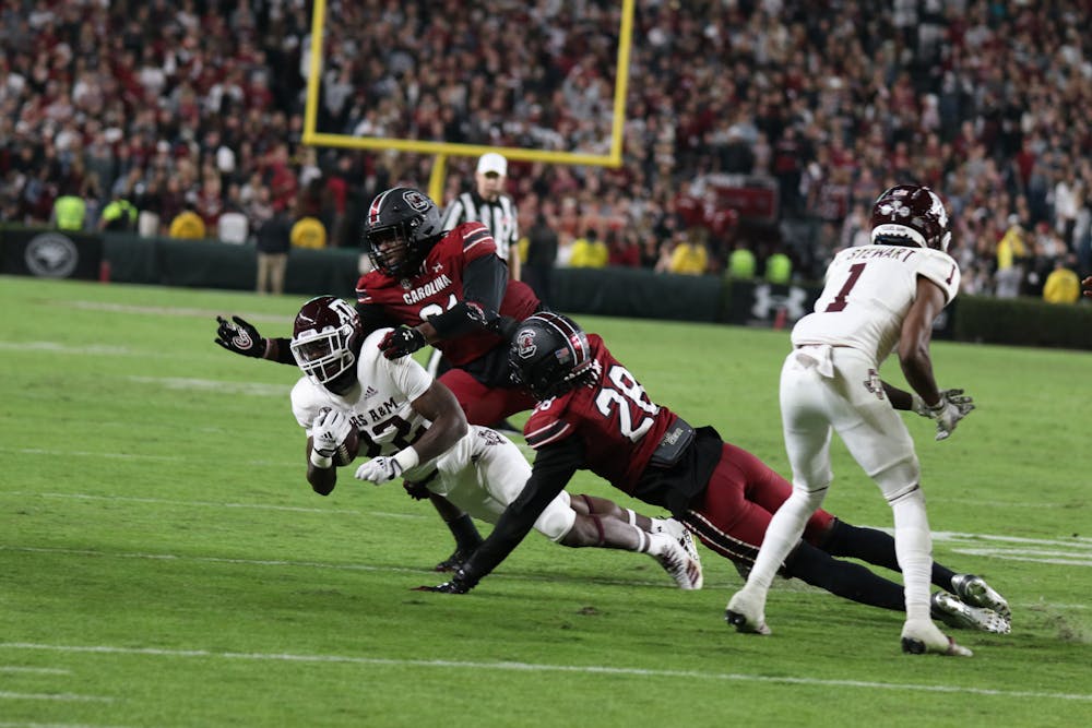 <p>Junior defensive lineman Tonka Hemingway and redshirt senior defensive back Darius Rush get the tackle during the fourth quarter against Texas A&amp;M at Williams-Brice Stadium on Oct. 22, 2022. The Aggies lost to the Gamecocks 30-24.</p>