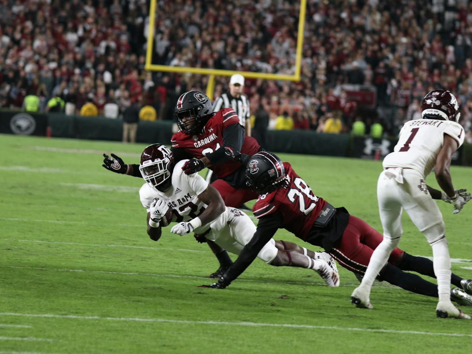 Junior defensive lineman Tonka Hemingway and redshirt senior defensive back Darius Rush get the tackle during the fourth quarter against Texas A&M at Williams-Brice Stadium on Oct. 22, 2022. The Aggies lost to the Gamecocks 30-24.
