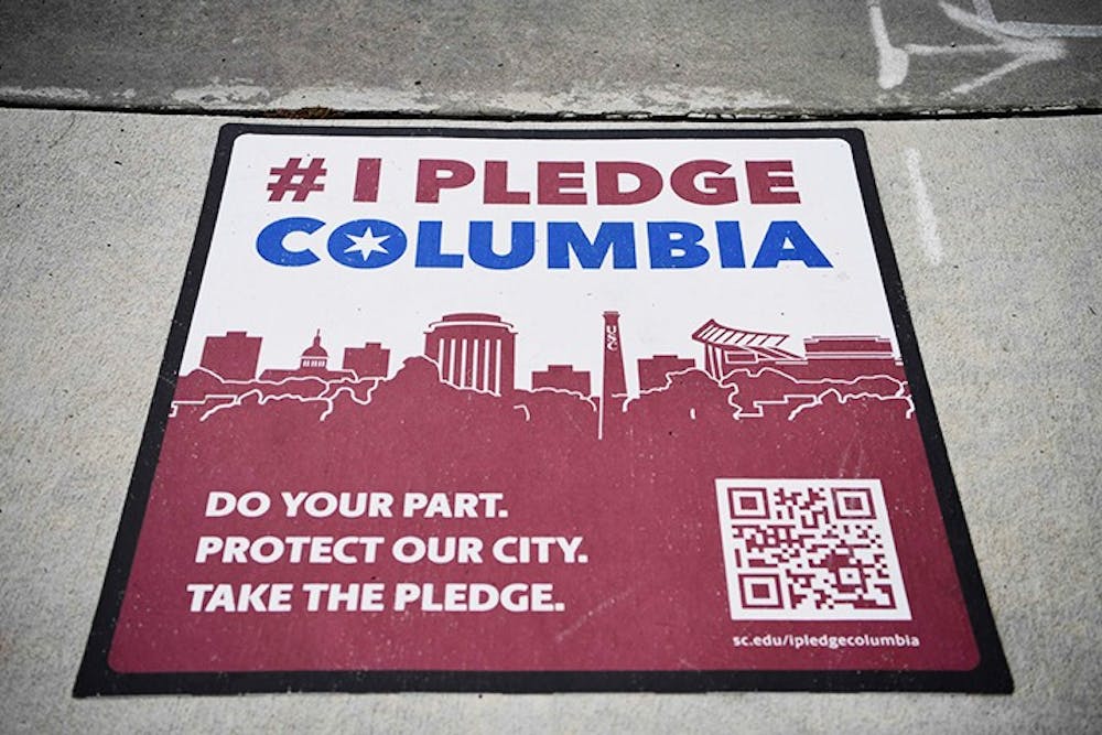 One of the many signs for #IPledgeColumbia sits on a sidewalk near campus.