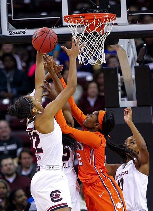 South Carolina&apos;s A&apos;ja Wilson (22) brings down a rebound against Clemson&apos;s MaKayla Johnson (12) during the first half at the Colonial Life Arena in Columbia, S.C., on Thursday, Nov. 20, 2014. (Tracy Glantz/The State/TNS)