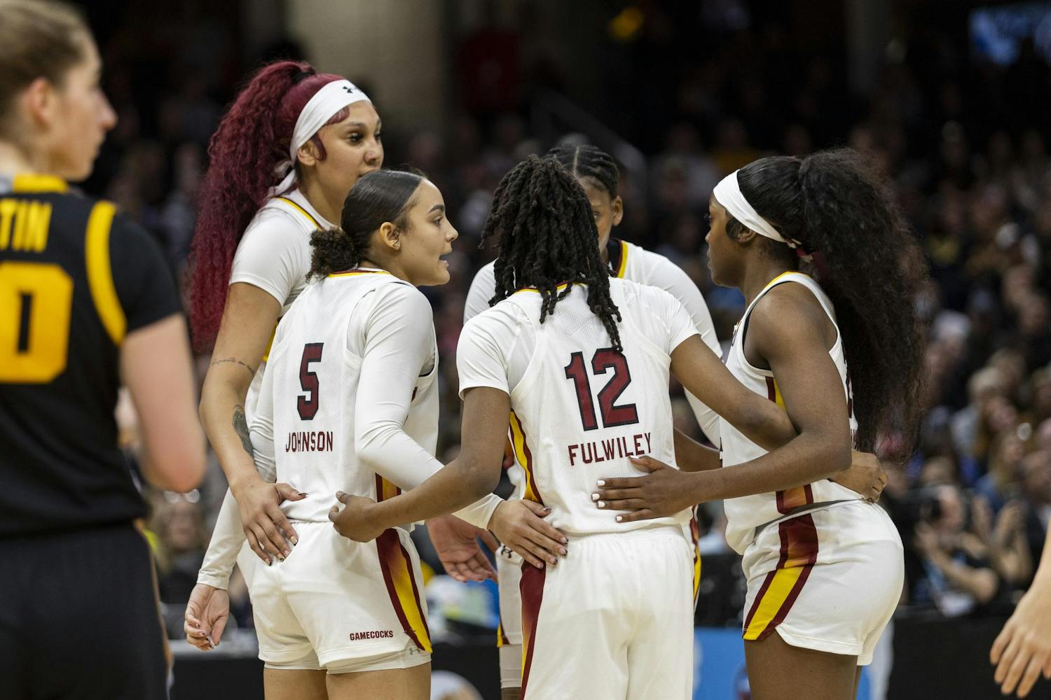 The Gamecocks huddle after a foul is called during the NCAA national championship game in Cleveland, Ohio. Both teams showed off the members' physicality throughout the game, with the Gamecocks tallying 17 fouls and the Hawkeyes totaling 14 fouls.